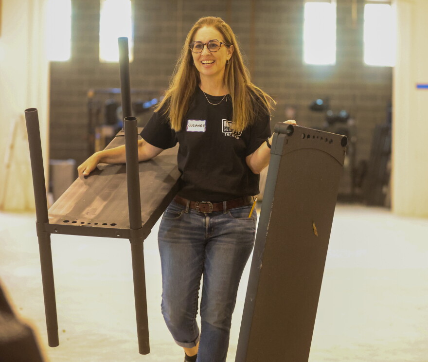 Julianne Baker, a member of Generic Theater's executive board, helping the company move into its new home at the Masonic Temple on Granby Street in Norfolk.