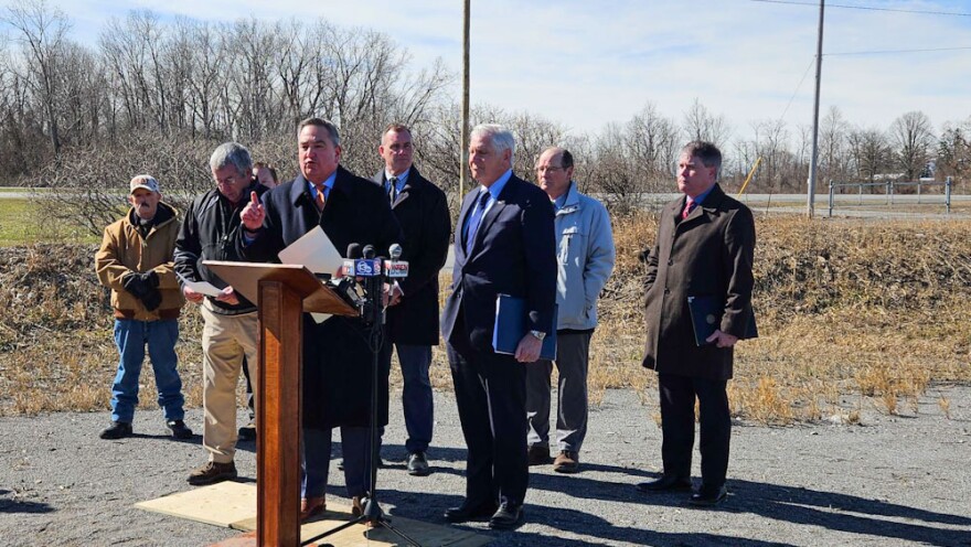 State Senator George Borrello, standing at lectern, speaks at a press conference in Genesee County.