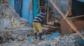 A man recovers what he can after a 7.2-magnitude earthquake struck Haiti. (Richard Pierrin/Getty Images)