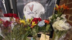 Memorial flowers and notes line walkway at Scott Stadium after three football players were killed in a shooting on the grounds of the University of Virginia Tuesday Nov. 15, 2022, in Charlottesville. Va. Authorities say three people have been killed and two others were wounded in a shooting at the University of Virginia and a student suspect is in custody. (AP Photo/Steve Helber)