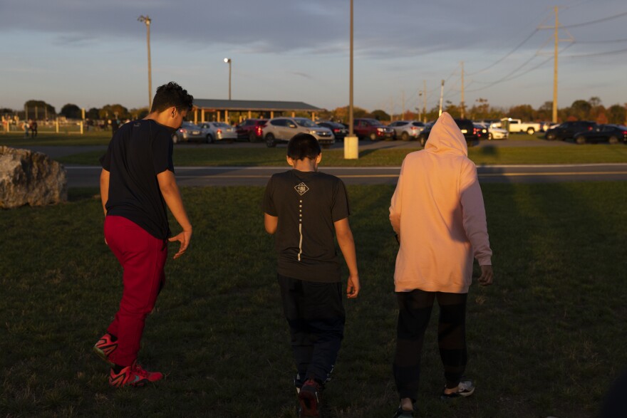 Veronica Vargas walks back to the car with her children.