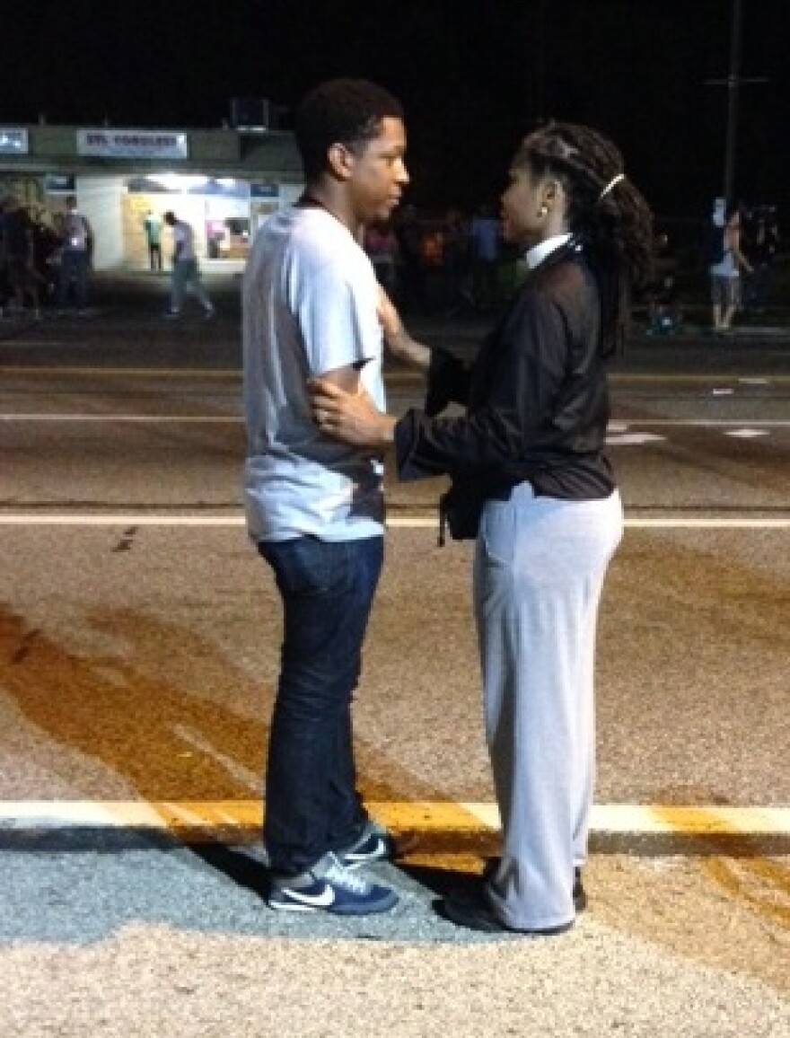 The Rev. Dinah Tatman, right, talking with a protester Monday night. 81814