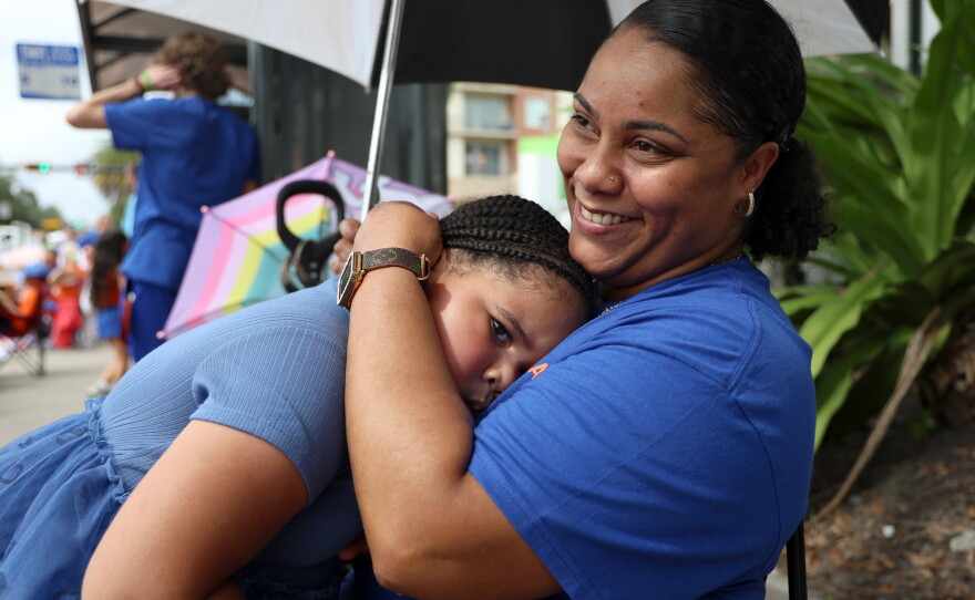 Kimbella Ellis, left, hugs her mother, Kimberly Ellis, right, during the University of Florida Homecoming parade in Gainesville Friday, Oct. 9, 2026. (Taylin Huffman/WUFT News)