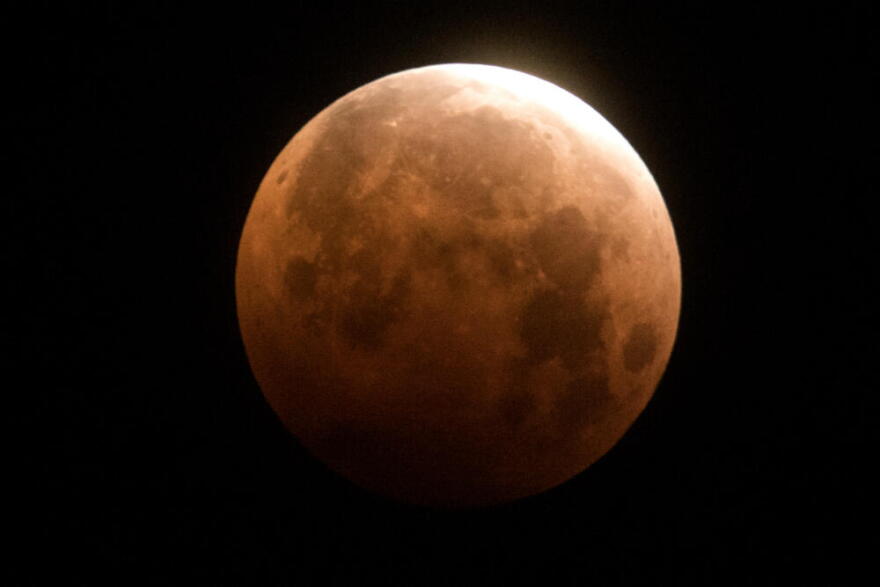 The total lunar eclipse is seen over Santa Monica Beach in Santa Monica, Calif., Wednesday, May 26, 2021. (Ringo H.W. Chiu/AP)