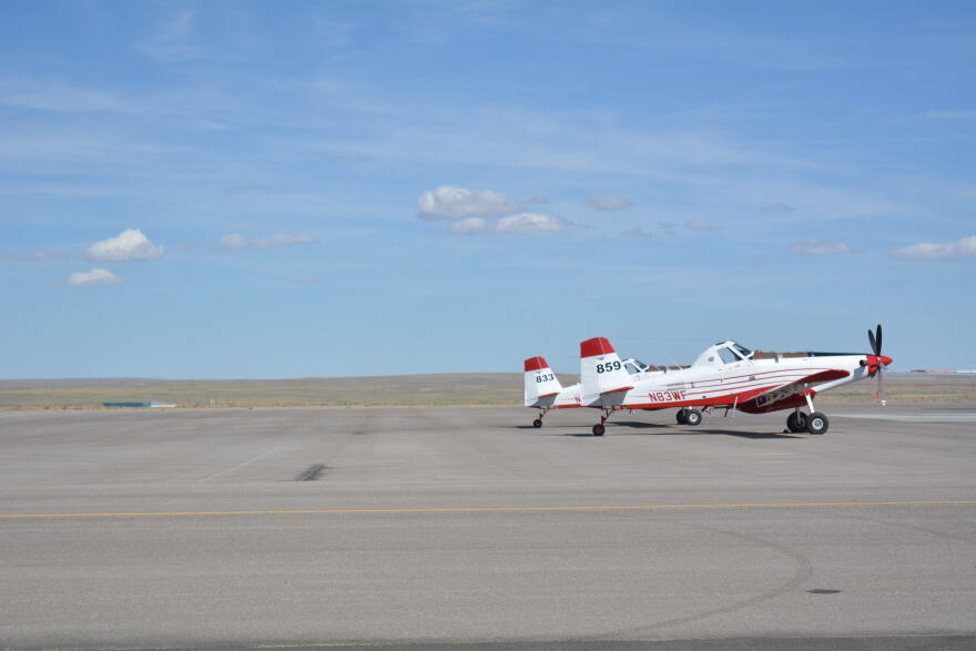 A firefighting plane sits on a runway.