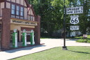 An entrance to Sprague's is seen, with replica gas pumps and a welcome sign.