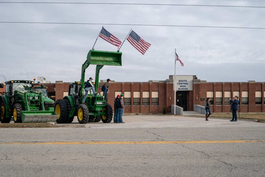 Parents and staff take pictures of students and their tractors at South Central High School's Drive Your Tractor To School Day.