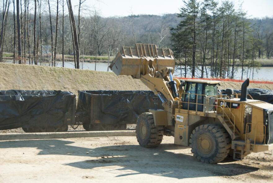 Workers load coal ash onto train cars at the Dan River plant in Eden in 2016. 