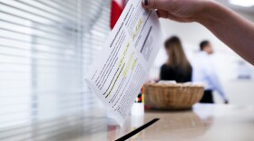 A voter casts their ballot on the first day of early voting at the Hamilton County Board of Elections, Wednesday, Oct. 10, 2018, in Cincinnati.