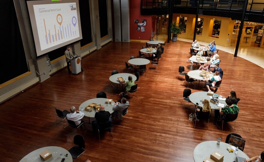 Overhead view of people seated at tables for conference.