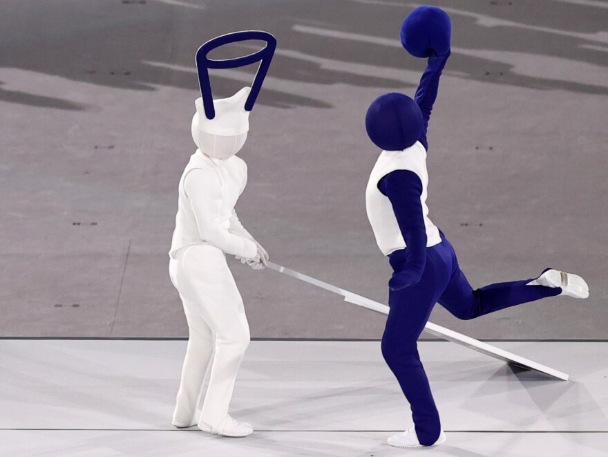 Performers acted out pictograms of basketball and other Olympic sports during the Tokyo Olympics' opening ceremony.