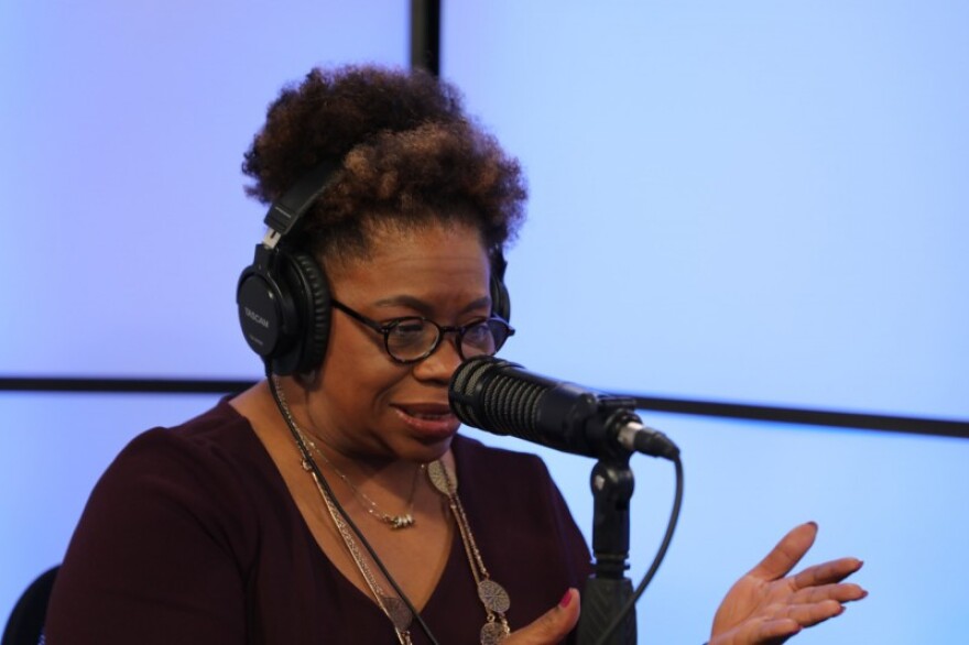 Cook Children's senior vice president Wini King speaks into a mic as she interviews a guest for the hospital systems new podcast, 'Raising Joy.'