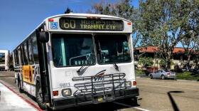 A VTA bus pulls up to a curb in Santa Clara