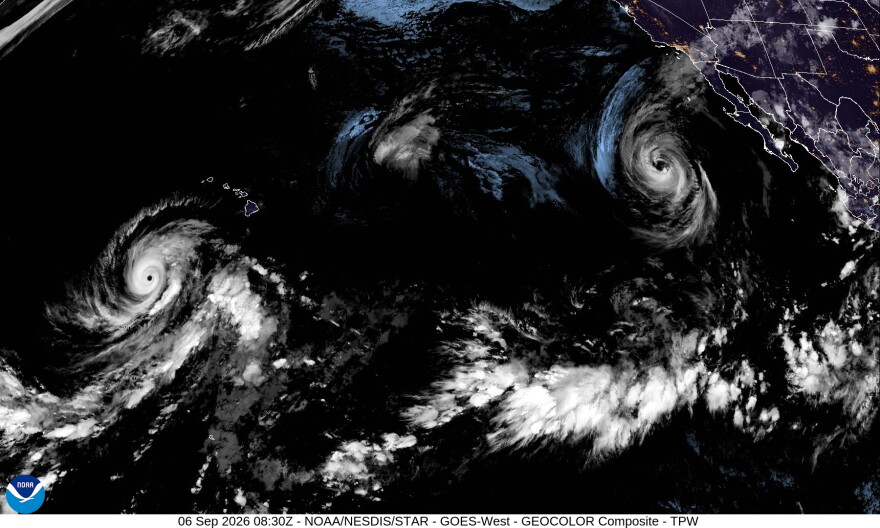 A satellite image shows from left to right, Hurricane Lowell, Tropical Storm Karina and Hurricane Marie in the Pacific on Saturday night.