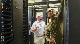 Fletch Batchelor (center) shows students around Louisiana Delta Community College's mock data center on Aug. 18, 2026.