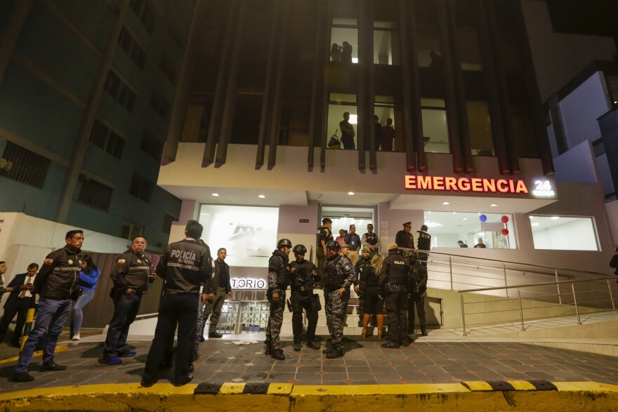 Police guard the hospital where several of the injured were taken after an attack against presidential candidate Fernando Villavicencio in Quito, Ecuador, on Wednesday.