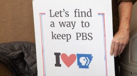 Supporters of PBS held up signs at the ArkansasTV commission meeting held on Thursday, March 12, 2026 in Conway, Arkansas.