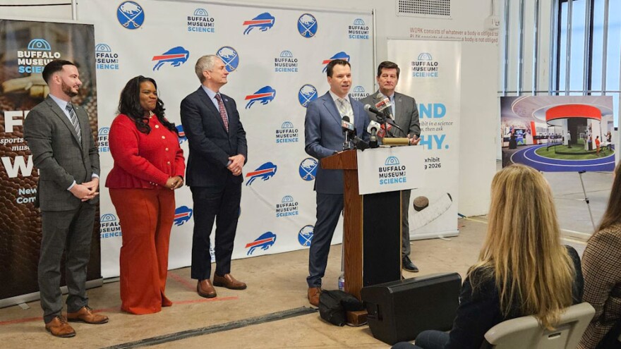 Buffalo Museum of Science CEO Gary Siddall, behind lectern, describes the future impact of the museum's Science Stadium exhibit, which opens in July.