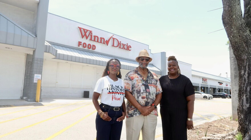 Left to right, Satin Fye, Ronald Frazier and Daniella Pierre stand in front of the shuttered Winn-Dixie in Liberty City.