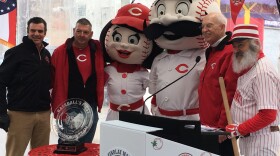 Findlay Market and the Reds looking ahead to the 100th parade and the 150th anniversary of professional baseball. From left: Reds President Phil Castellini, Parade Chair Neil Luken, mascots, and former radio personality Jim Scott.