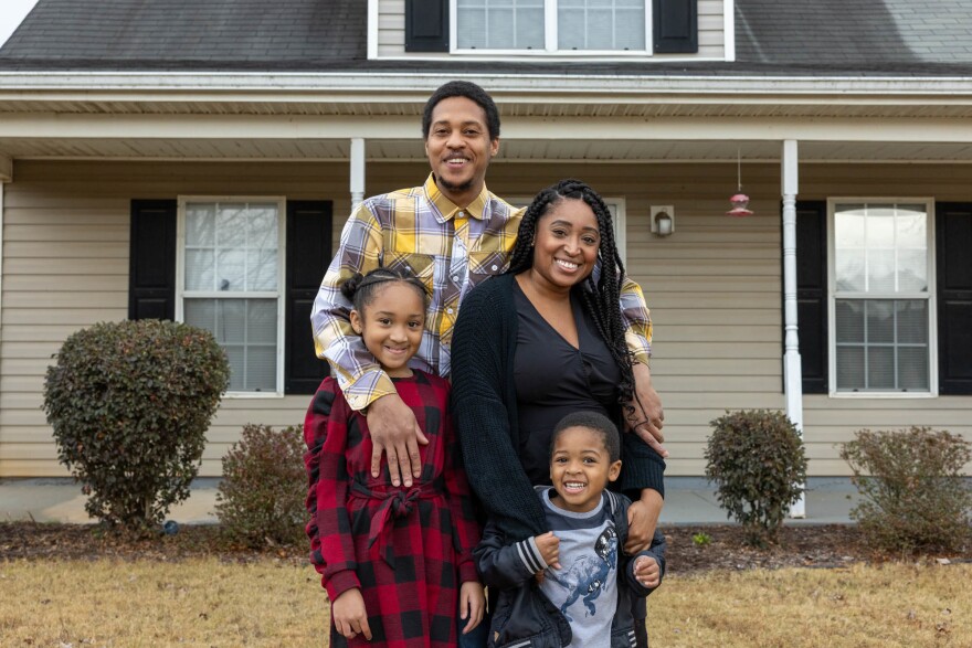 TUESDSAY, DECEMBER 7, 2021 - GRIFFIN, GA - Nicole Howson and her family stand in front of their home in Griffin, Ga. L-R Clockwise Latroun Epps, Nicole, Talysa Epps and Israel Epps. Lynsey Weatherspoon for NPR