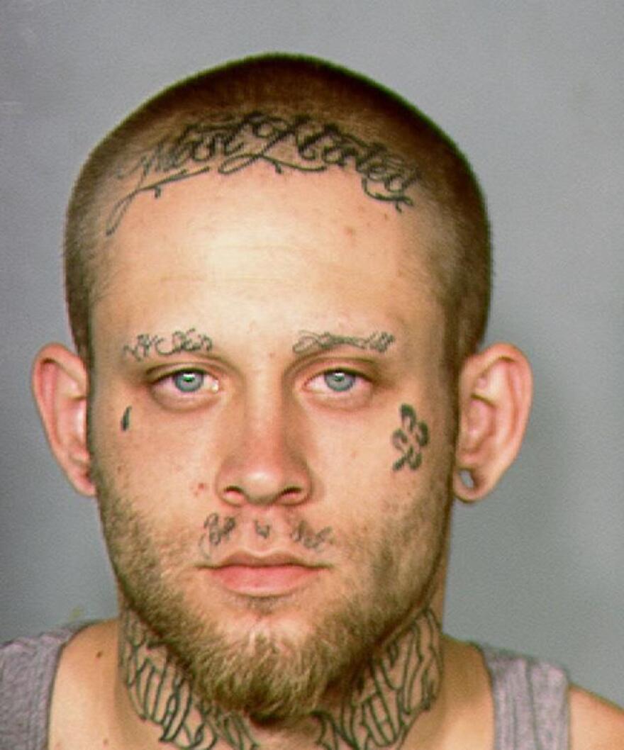 This 2013 law enforcement booking photo provided by the Las Vegas Metropolitan Police Department shows Bayzle Morgan. A Las Vegas judge has ordered a cosmetologist to cover Morgan's neck and facial tattoos that include a swastika and the words "Most Wanted" on each day of his robbery trial, in an effort to get him a fair trial.
