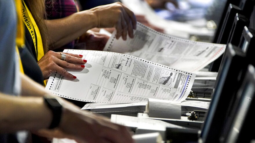 FILE - Election workers perform a recount of ballots from the recent Pennsylvania primary election at the Allegheny County Election Division warehouse on the Northside of Pittsburgh, June 1, 2022.
