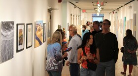 Visitors mingle with artists at the "Round and Around" exhibition on opening night, June 2.