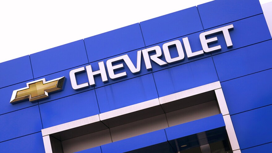 The Chevrolet logo is displayed on the facade of a dealership , Tuesday, Aug. 3, 2021, in Woburn, Mass. Despite a computer chip shortage that temporarily closed some of its factories, General Motors made a healthy $2.8 billion second-quarter net profit in the second quarter.