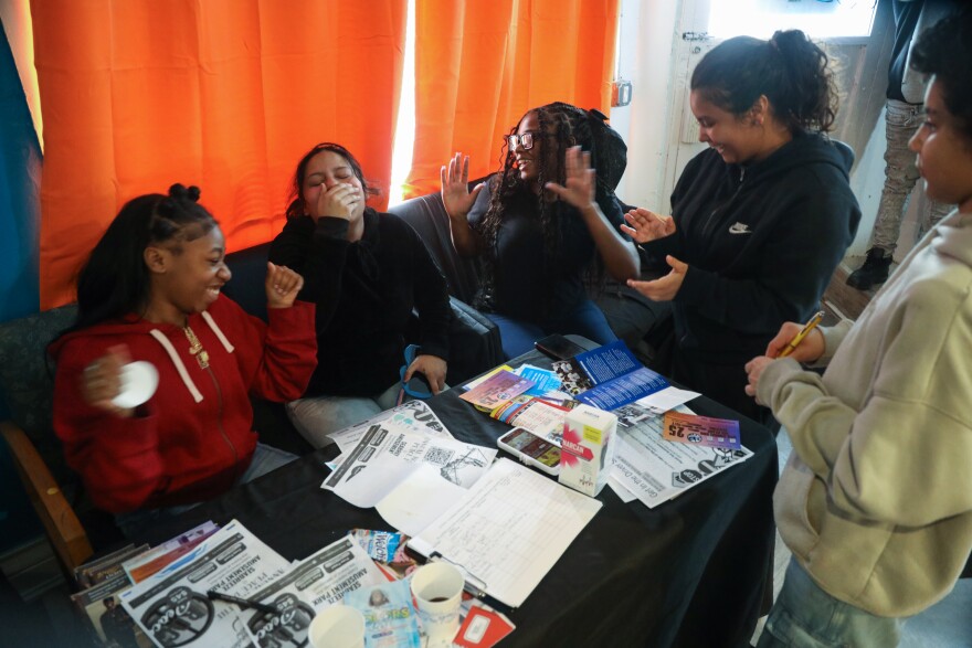 Teens attend the grand opening for the new Northside hub of the Center for Teen Empowerment, listening to music on their phones. The organization is expanding its reach in Rochester with a new location at Dewey and Magee avenues in the historic Maplewood neighborhood.