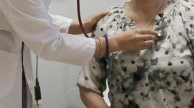 A doctor examines a patient at a clinic in Stanford, California. (Jeff Chiu/AP)