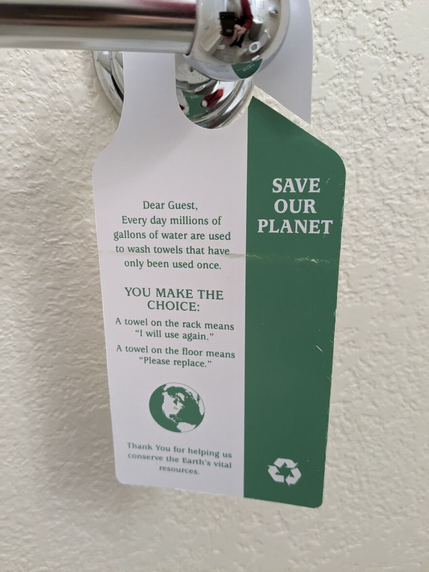 Hotel door hanger with tips for staying green while staying at a hotel.