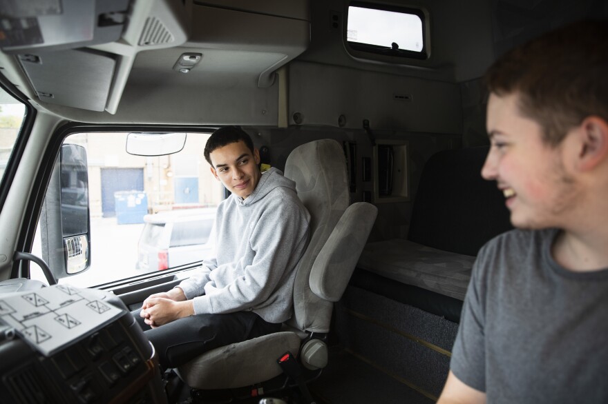 Seniors Peter Vilas Novas and Joshua Hewitt chat in the cab of the truck they're learning on. Both think they'd like to get into long-haul trucking once they earn their commercial driver licenses.
