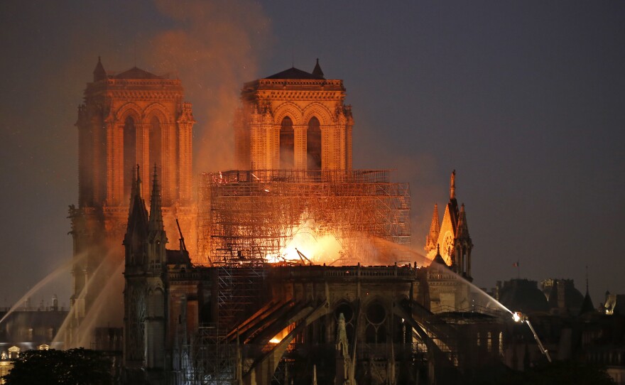 Flames and smoke are seen billowing from the roof at Notre Dame Cathedral in Paris on Monday.