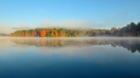 A lake with morning fog in fall.