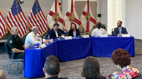 People sitting around a dais