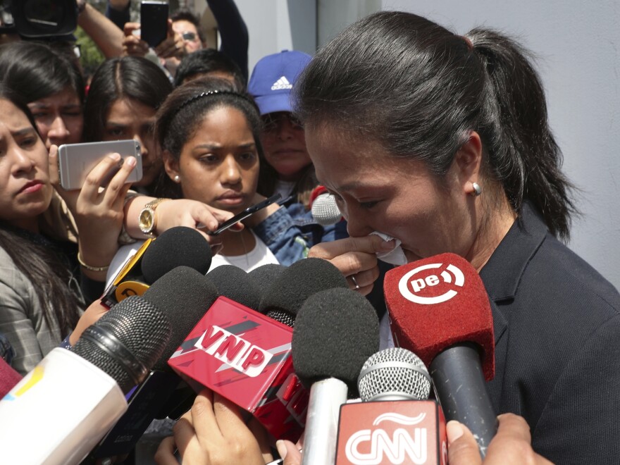 Keiko Fujimori, daughter of Peru's former President Alberto Fujimori, cries as she speaks with reporters outside her father's home in Lima on Wednesday.