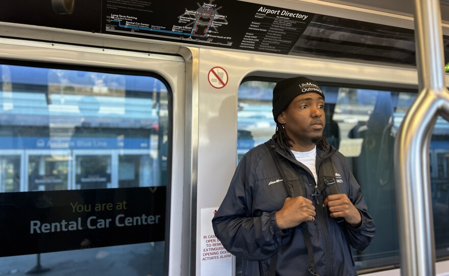 James Paxton, a Case Manager for LifeMoves, rides the AirTrain during an early morning homeless outreach trip to SFO.