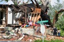 Residents at Clearence and Labadie Avenues assess the damage to their home after the May 16 tornado rolled through the Ville neighborhood of north St. Louis.