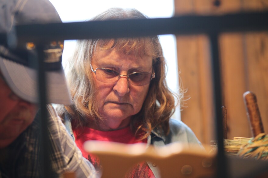 Wanda and her husband Steve work on the broom making machine they purchased from Jim Shaffer.