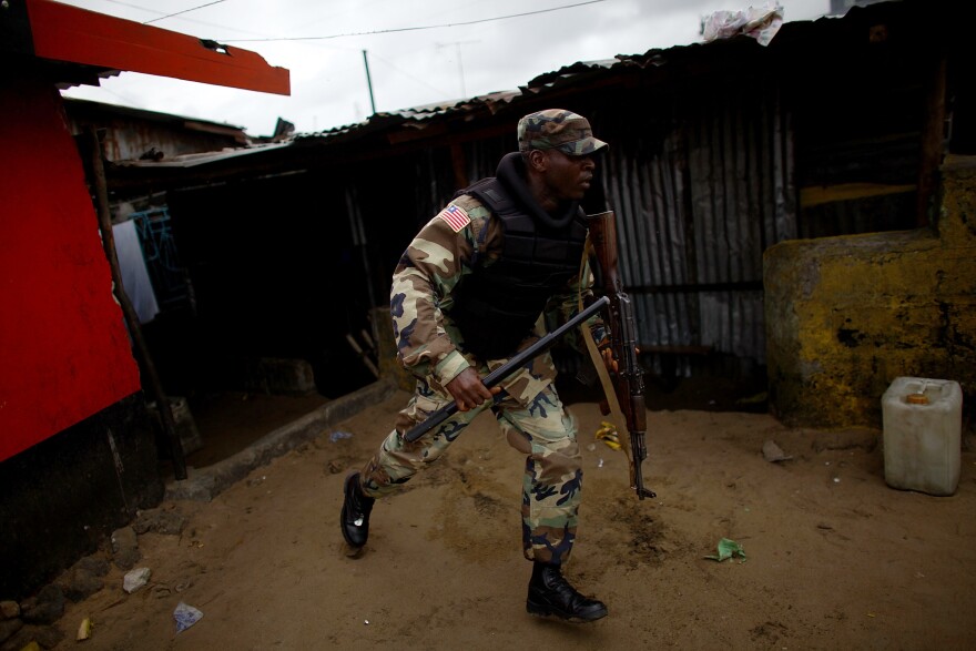 A soldier chases protesters through West Point.