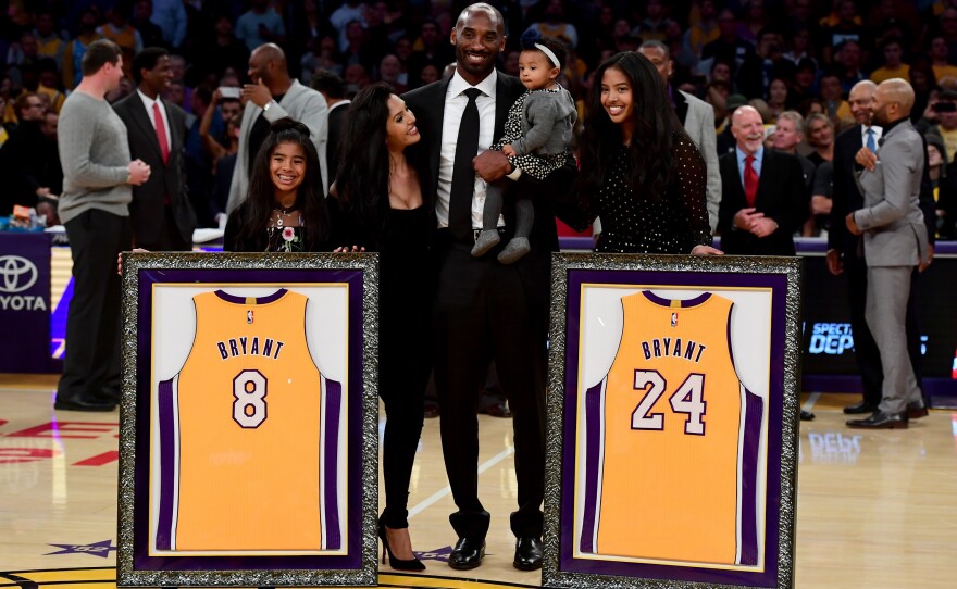 Kobe Bryant poses with his family at halftime after both his #8 and #24 Los Angeles Lakers jerseys are retired at the Staples Center on Dec. 18, 2017, in Los Angeles.