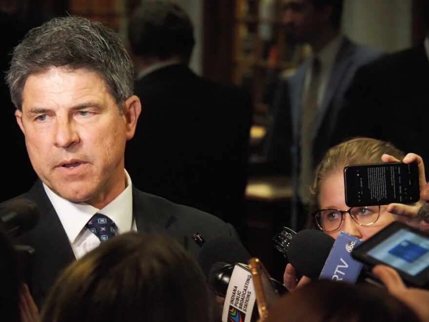 A man speaks to news media