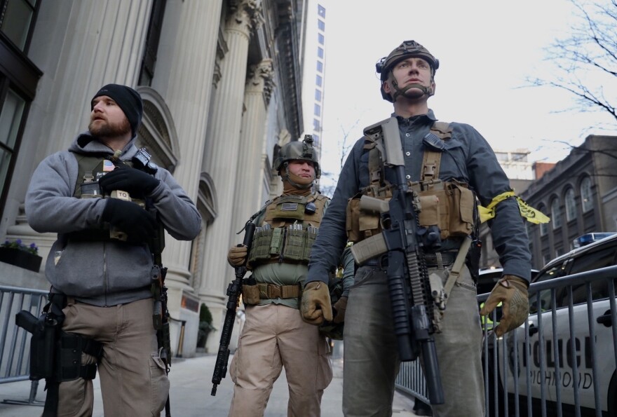 Rally attendees walked with their firearms in plain sight on streets around the state Capitol, even though event organizers asked supporters to show up unarmed.