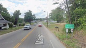 google streetview of a road with cars and a Hamden village sign.