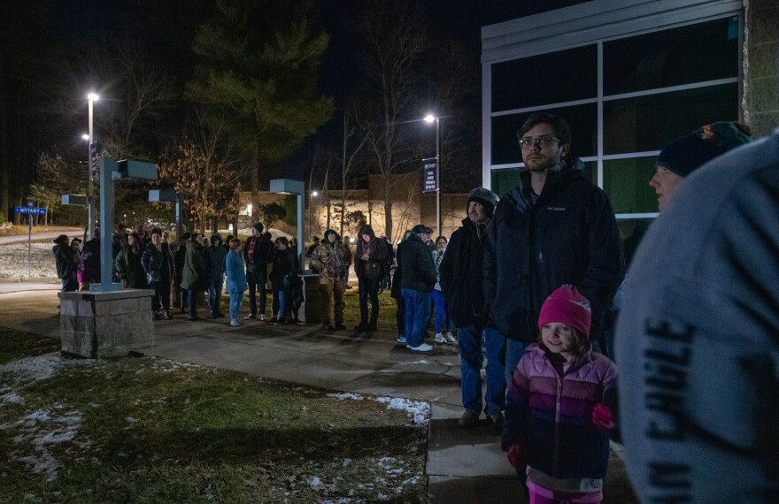 A line of people eager to see the comet C/2022 E3 ZTF snakes around the building outside of the observatory.