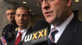 Assistant U.S. Attorney Brett Harvey (right) speaks to reporters after Emanuel Lutchman sentencing.