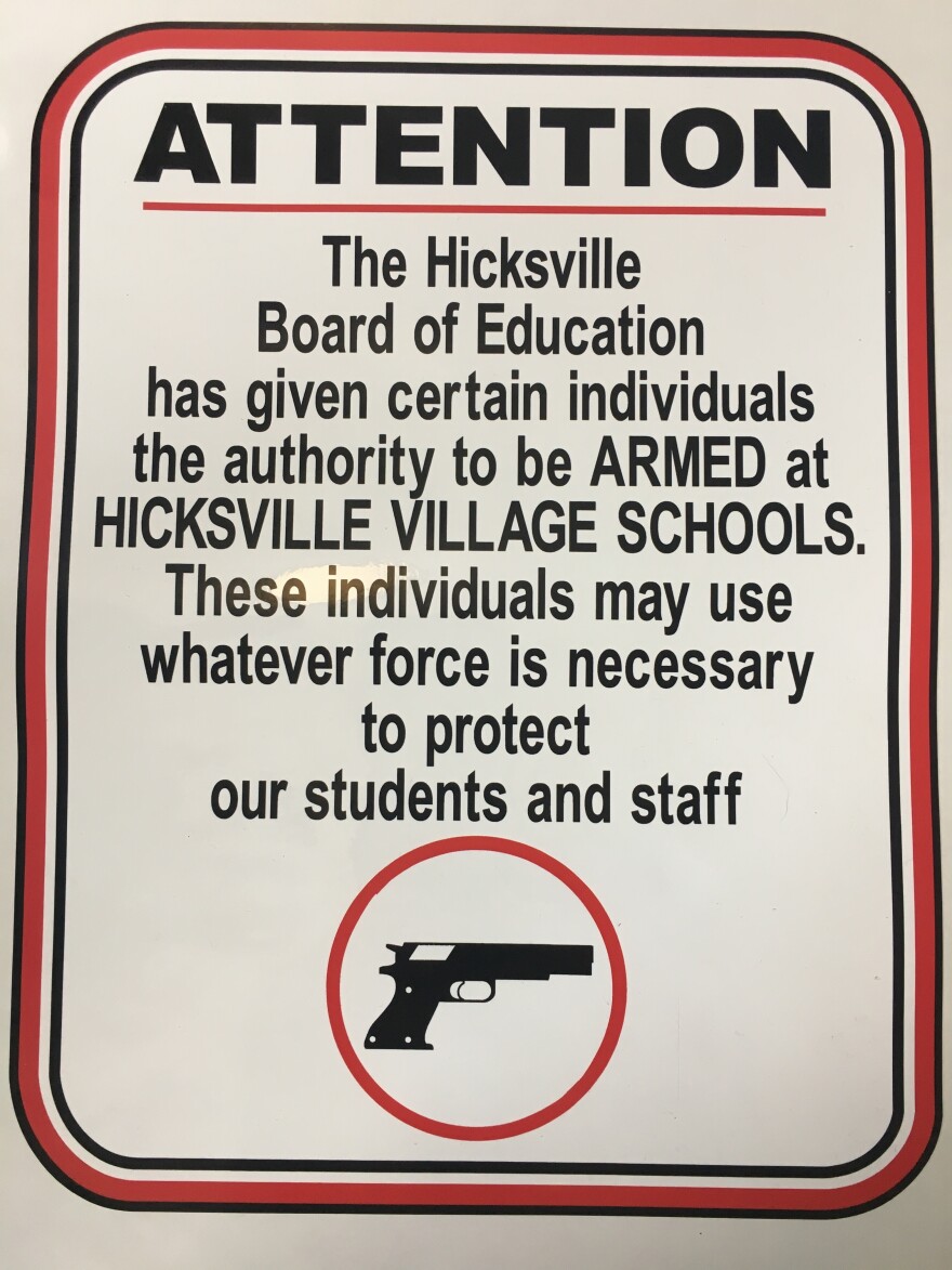 A sign outside Hicksville schools warns visitors that teachers are armed.