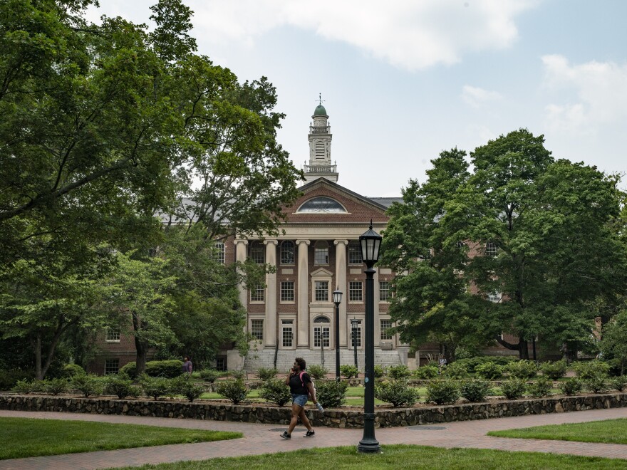 People walk on the campus of the University of North Carolina Chapel Hill in June.