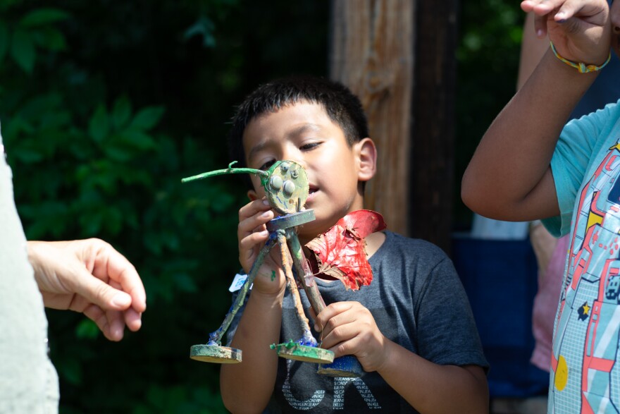Ezequiel holds "Steve" the alebrije.